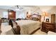 Large main bedroom features a ceiling fan, an upholstered bed, and ample furniture at 2440 Weatherford Ct, Marietta, GA 30068
