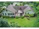 Spacious home featuring a deck, outdoor seating, a grill, and a swing amidst a lush, green lawn at 2440 Weatherford Ct, Marietta, GA 30068