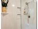 Luxurious shower with marble tile, built-in shelving and a glass enclosure at 2440 Weatherford Ct, Marietta, GA 30068