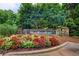 Welcome to Weatherstone, featuring a stone entrance sign with vibrant floral landscaping at 2440 Weatherford Ct, Marietta, GA 30068