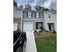 Charming two-story townhome with a one car garage, welcoming landscaping, and neutral gray tones at 2554 Coventry Sw St, Atlanta, GA 30331