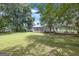 Expansive backyard with mature trees, and features a carport and house at 33 Russell Rd, Mcdonough, GA 30252