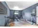 The basement area features exercise equipment and painted blue walls at 33 Russell Rd, Mcdonough, GA 30252