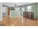 Well-lit dining area with barstool seating, hardwood floors, and a view of the kitchen at 33 Russell Rd, Mcdonough, GA 30252