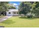 This home features a well-kept front yard with lush green grass and mature trees at 33 Russell Rd, Mcdonough, GA 30252