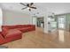 Open-concept living space with hardwood floors, a spacious red sectional, and modern lighting at 33 Russell Rd, Mcdonough, GA 30252