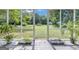 View of screened in porch, with outdoor plants and backyard views at 33 Russell Rd, Mcdonough, GA 30252