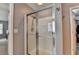 Bathroom featuring a glass-enclosed shower, neutral walls, and a view into the walk-in closet at 3845 Lake Lanier Dr, Duluth, GA 30097