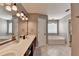 Well-lit bathroom with dual sinks, a soaking tub, and neutral tile flooring, great for relaxation at 3845 Lake Lanier Dr, Duluth, GA 30097