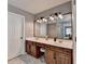Primary bathroom features a double vanity, wood cabinetry, and stylish fixtures and decor at 3845 Lake Lanier Dr, Duluth, GA 30097
