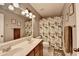 Bright bathroom featuring double sinks, wood vanity, and floral shower curtain at 3845 Lake Lanier Dr, Duluth, GA 30097