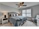 Cozy bedroom with a comfortable bed, ceiling fan, and soft lighting for a relaxing ambiance at 3845 Lake Lanier Dr, Duluth, GA 30097