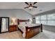 Spacious bedroom features a large bed, ceiling fan, and ample natural light from the window at 3845 Lake Lanier Dr, Duluth, GA 30097