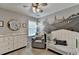 Charming Bedroom features a whimsical mural, white crib, dresser, and gray rocking chair at 3845 Lake Lanier Dr, Duluth, GA 30097