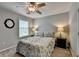 Cozy bedroom with neutral tones, ceiling fan, and patterned bedding at 3845 Lake Lanier Dr, Duluth, GA 30097