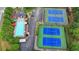 Aerial view of a pool and tennis courts, providing a variety of recreational options for residents at 3845 Lake Lanier Dr, Duluth, GA 30097