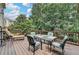 Inviting wooden deck with a dining table, chairs, and lounge, ideal for outdoor gatherings and relaxation at 3845 Lake Lanier Dr, Duluth, GA 30097