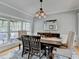 Cozy dining room showcasing wood table, chairs, and large windows with natural light at 3845 Lake Lanier Dr, Duluth, GA 30097