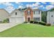 Charming two-story home with a well-manicured lawn, brick accents and an attached two-car garage at 3845 Lake Lanier Dr, Duluth, GA 30097