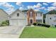 Charming two-story home with a well-manicured lawn, brick accents and an attached two-car garage at 3845 Lake Lanier Dr, Duluth, GA 30097