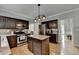 Well-equipped kitchen features a center island, stainless steel appliances, and hardwood floors at 3845 Lake Lanier Dr, Duluth, GA 30097