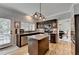 Modern kitchen featuring granite countertops, dark cabinetry, and stainless steel appliances at 3845 Lake Lanier Dr, Duluth, GA 30097