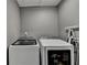 Functional laundry room area with white washer and dryer at 3845 Lake Lanier Dr, Duluth, GA 30097