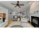 Cozy living room features a ceiling fan, fireplace, and seating area with stylish decor and wooden floors at 3845 Lake Lanier Dr, Duluth, GA 30097