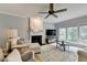Comfortable living room with large windows, a fireplace, and neutral-toned furniture at 3845 Lake Lanier Dr, Duluth, GA 30097