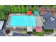 Aerial view of a community pool with lounge chairs and colorful umbrellas, perfect for summer relaxation at 3845 Lake Lanier Dr, Duluth, GA 30097