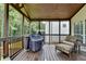 Covered porch featuring a grill and comfortable seating, providing a cozy outdoor space for relaxing and entertaining at 3845 Lake Lanier Dr, Duluth, GA 30097