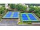 Aerial view of community tennis courts with new surfacing and lighting for recreational enjoyment at 3845 Lake Lanier Dr, Duluth, GA 30097