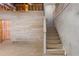 Unfinished basement showing stairs, wooden paneling and exposed utilities at 77 Skyland Dr, Roswell, GA 30075