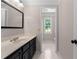 Bathroom with a vanity and mirror, and a doorway to another area at 77 Skyland Dr, Roswell, GA 30075