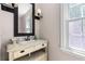 Charming bathroom featuring a vintage-style vanity and abundant natural light from the window at 77 Skyland Dr, Roswell, GA 30075