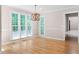 Sunlit breakfast nook featuring large windows, a wooden chandelier, and hardwood floors at 77 Skyland Dr, Roswell, GA 30075