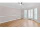 Bright dining room featuring hardwood floors, decorative molding, and large shuttered windows at 77 Skyland Dr, Roswell, GA 30075