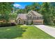 Beautiful two-story home with manicured lawn, stone accents, and attached garage at 77 Skyland Dr, Roswell, GA 30075