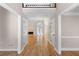 Inviting foyer with gleaming hardwood floors, leading to a spacious living area with a fireplace and lots of light at 77 Skyland Dr, Roswell, GA 30075