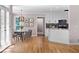 Open-concept view of a kitchen featuring white cabinets, stainless appliances, and a cozy dining area at 77 Skyland Dr, Roswell, GA 30075
