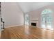 Bright and airy living room with hardwood floors, a fireplace, high ceilings, and French doors to the outdoors at 77 Skyland Dr, Roswell, GA 30075