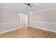 Light-filled living room with hardwood floors, decorative molding, and an open floor plan at 77 Skyland Dr, Roswell, GA 30075