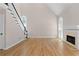 Bright and airy living room with hardwood floors, a fireplace, high ceilings, and French doors to the outdoors at 77 Skyland Dr, Roswell, GA 30075