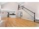 Bright and airy living room with hardwood floors, a fireplace, high ceilings, and staircase to the second level at 77 Skyland Dr, Roswell, GA 30075