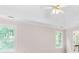 Bright main bedroom with a ceiling fan and windows offering a view of the surrounding greenery at 77 Skyland Dr, Roswell, GA 30075