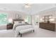 Spacious main bedroom featuring neutral tones, a tray ceiling, and lots of natural light at 77 Skyland Dr, Roswell, GA 30075