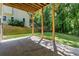 Covered patio area with concrete flooring, wood beams, and view of the landscaped backyard at 77 Skyland Dr, Roswell, GA 30075
