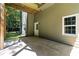Under-deck patio featuring concrete flooring, exterior door, and home's siding at 77 Skyland Dr, Roswell, GA 30075