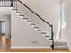 Elegant staircase featuring a striking black and white design and a charming arched window at 77 Skyland Dr, Roswell, GA 30075