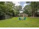 Extensive backyard with a shed, adirondack chairs around a fire pit, and a well-maintained lawn at 91 Tatum St, Marietta, GA 30060